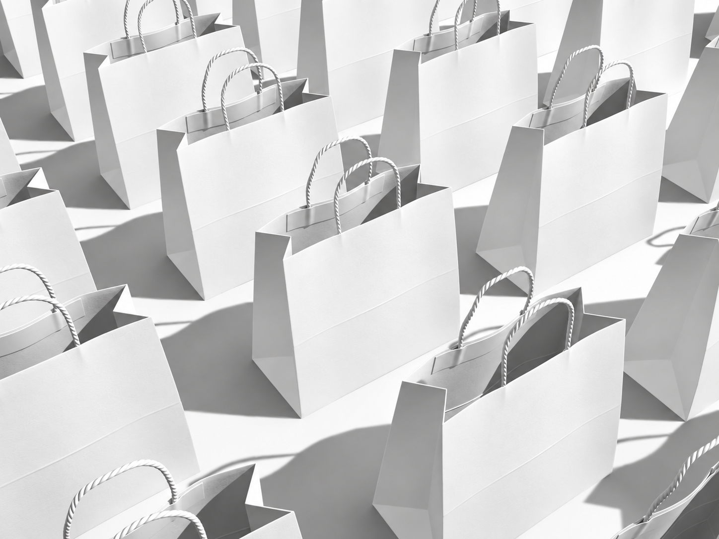 Rows of white paper shopping bags casting geometric shadows